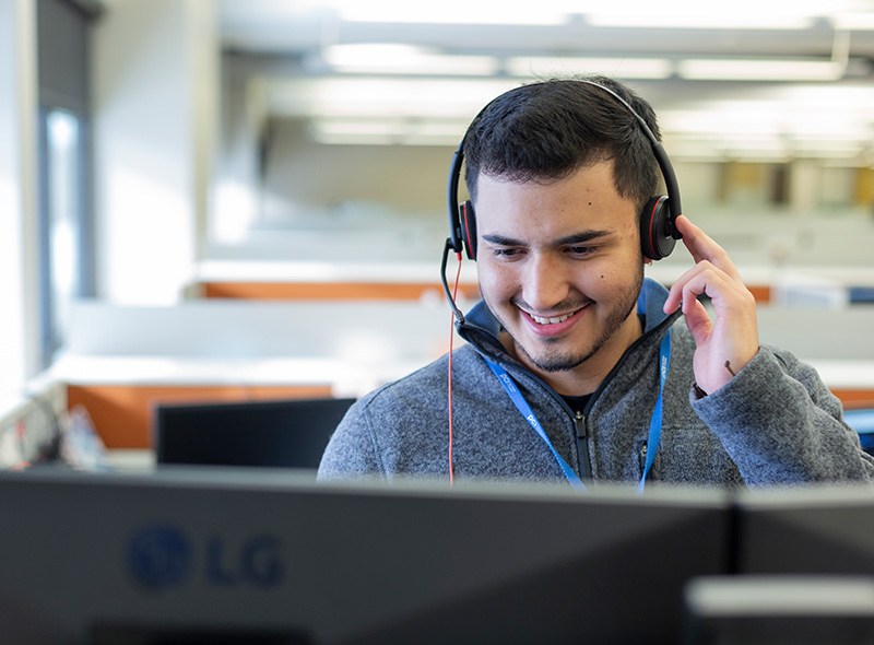 PCI employee with blonde hair wearing headset